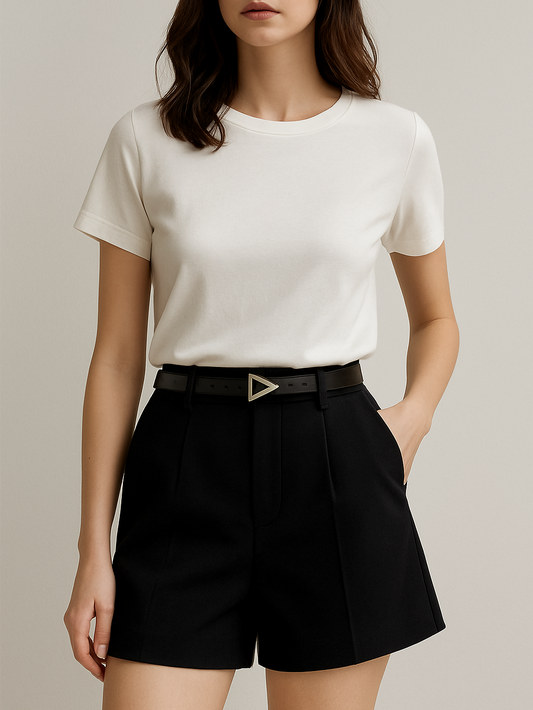 Person wearing a white t-shirt and black shorts with a belt on a neutral background